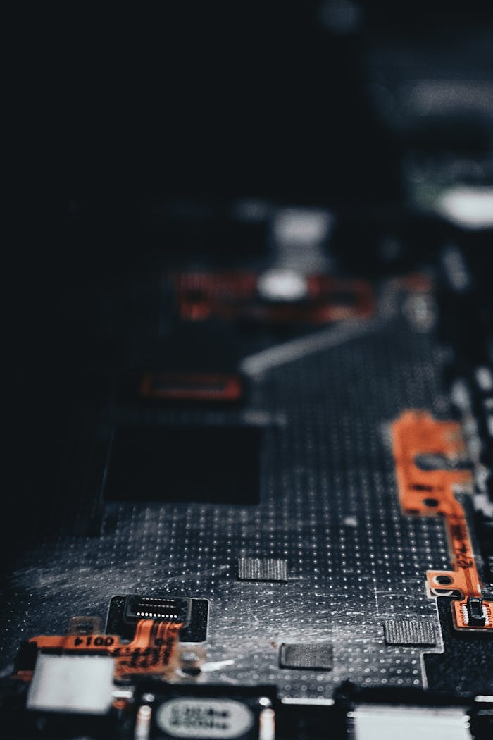 Close-up of a dark circuit board showcasing electronic components and connections.